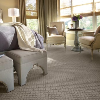 Yates Flooring Center - a bedroom with a bed and a chair - Flooring Near Me - Midland, Texas Yates Flooring Center - a bedroom with a bed and a chair - Flooring Near Me - Midland, Texas