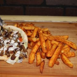 Wrapped in a toasted pita with your choice of meat sautéed in grilled onions and a traditional seasoned salad.