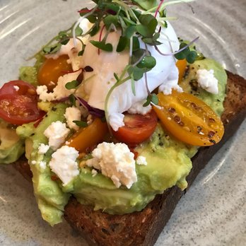 Bluestone Lane DUMBO Café - Avo toast with poached egg, cherry tomatoes and feta. - Coffee & Tea Near Me - Brooklyn, New York