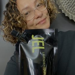Owner Mindy with her non toxic formulation Hair Glaze JEL for shiny no frizz curls.