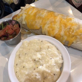 Sunrise Bistro - Enchilada ranchero add chicken, with grits and salsa - Breakfast & Brunch Near Me - Charleston, South Carolina Sunrise Bistro - Enchilada ranchero add chicken, with grits and salsa - Breakfast & Brunch Near Me - Charleston, South Carolina