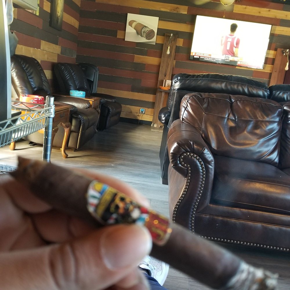 Smoke & Vape  - a hand holding a cigar - Vape Shops Near Me - Norfolk, Virginia