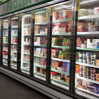 Dollar Tree - Decent selection of frozen & refrigerated foods. - A supermarket freezer case with glass doors contains various frozen and refrigerated food products, including ice cream and meals. - Discount Store Near Me - Albuquerque, New Mexico