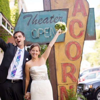 Acorn Theater - a bride and groom standing in front of the acorn sign - Performing Arts Near Me - Three Oaks, Michigan Acorn Theater - a bride and groom standing in front of the acorn sign - Performing Arts Near Me - Three Oaks, Michigan