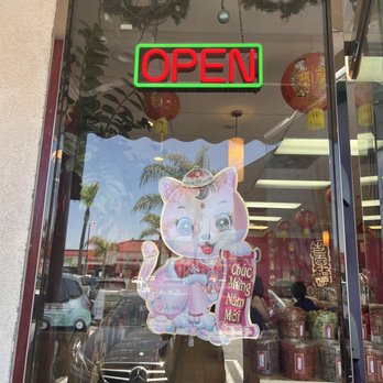 Vua Tra - an open sign in a store window - Imported Food Near Me - Westminster, California Vua Tra - an open sign in a store window - Imported Food Near Me - Westminster, California