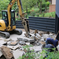 Tanner Excavating - Breaking up concrete in order to replace a sewer line.
