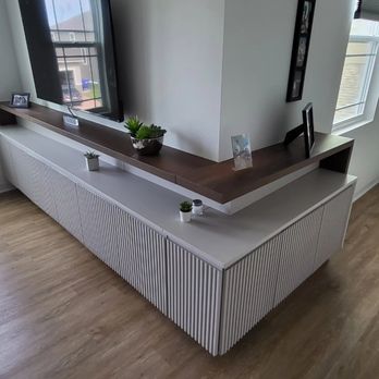Liguori Home Concept - a living room with a tv on the wall - General Contractors Near Me Liguori Home Concept - a living room with a tv on the wall - General Contractors Near Me
