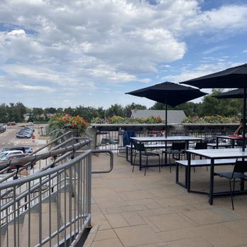 Ivywild Kitchen - a patio with tables and umbrellas - American Near Me - Colorado Springs, Colorado