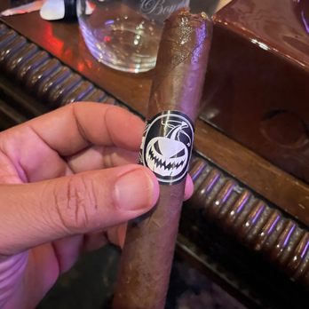 Charles P Stanley Cigar Bar - a hand holding a cigar - Tobacco Shops Near Me - Saint Louis, Missouri