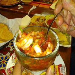 Shrimp cocktail after half already eaten.