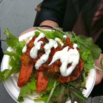 Feastro - a person holding a plate of food - Food Stands Near Me - Vancouver, British Columbia