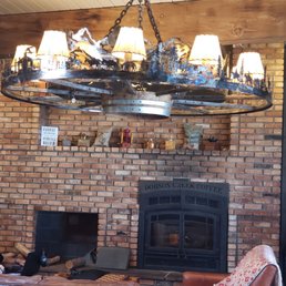 a large chandelier hanging over a fireplace a large chandelier hanging over a fireplace