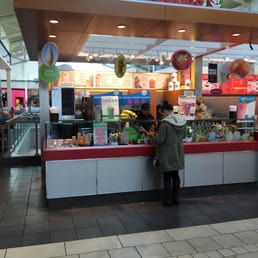 a woman standing at the counter of a fast food restaurant