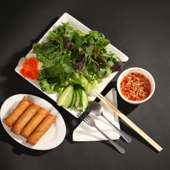Com Viet - a plate of food and a bowl of dipping sauce - Vietnamese Near Me - Garden Grove, California