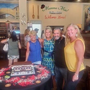 Mamma Mia - a group of people standing in front of a table with a cake - Italian Near Me - Holly Springs, North Carolina Mamma Mia - a group of people standing in front of a table with a cake - Italian Near Me - Holly Springs, North Carolina