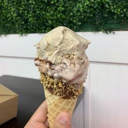 a hand holding an ice cream cone a hand holding an ice cream cone