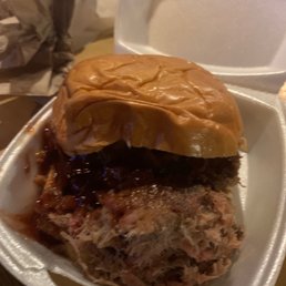 a pulled pork sandwich in a styrofoam container a pulled pork sandwich in a styrofoam container