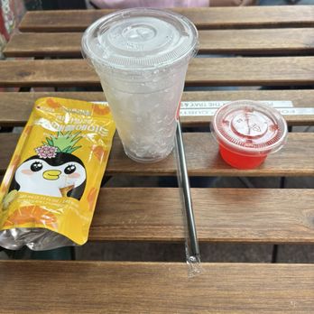 Slurp & Sip - Pineapple Ade drink pouch, cup full of ice, strawberry popping boba - Juice Bars & Smoothies Near Me - Los Angeles, California