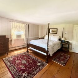 Colonel Spencer Inn - The Baker Room features a Queen-size 4-poster cherry canopy bed, a sitting chair for reading, and has a full tub bath with shower.