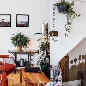 Café Sfouf - a living room with a red chair and a coffee table - Cafes Near Me - Montreal, Quebec