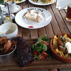 The Farm - BBQ ribs, chilli wings, and pulled pork nachos plate.