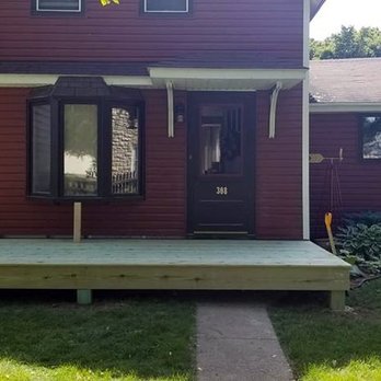 Mikes Remodeling - a man standing in front of a house - General Contractors Near Me