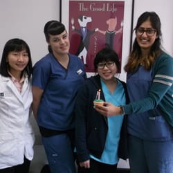 Wellesley Animal Hospital - Some of the staff celebrate the clinic's anniversary with a cupcake.