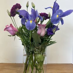 Nosegay Floral Designs - The vase is a clear "book" and it reads, 'The Mystery of Growth' on the spine and on the front it says the same & 'A Book About Flowers'.'