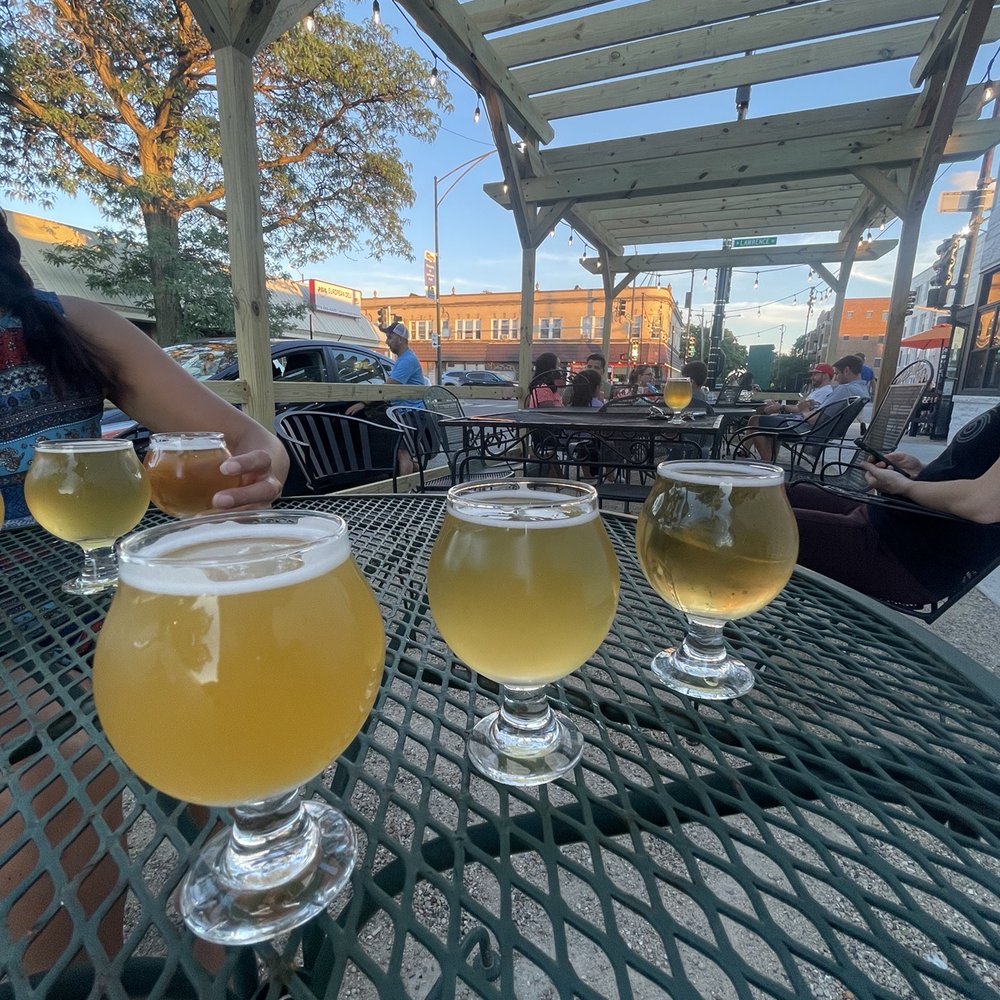 Flight of blonde beers under pergola Flight of blonde beers under pergola