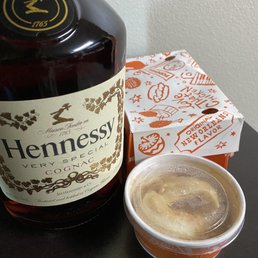 a bottle of hennessy whiskey and a cup of coffee a bottle of hennessy whiskey and a cup of coffee