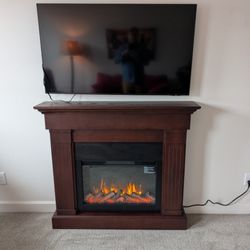 Dallas County Handyman - A TV mount and  freestanding electric fireplace make this West Des Moines spare bedroom a cozy getaway.