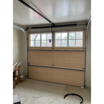 Hawk Garage Doors - Interior view of a natural wood carriage-style garage door with windows -- Hawk Garage Doors - Garage Door Services Near Me Hawk Garage Doors - Interior view of a natural wood carriage-style garage door with windows -- Hawk Garage Doors - Garage Door Services Near Me