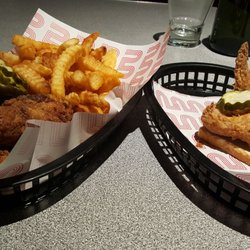 Belles Hot Chicken - Three drumstick combo with Old Bay Seasoning fries on the left and ala carte chicken wing on the right.