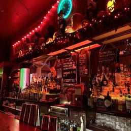a bar with a neon clock above the bar a bar with a neon clock above the bar