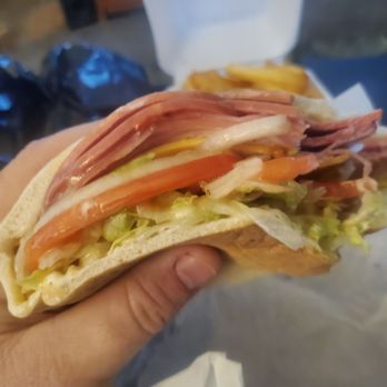Ashley's Place Sandwich Shop - a hand holding a sandwich - Breakfast & Brunch Near Me - Jacksonville, Florida