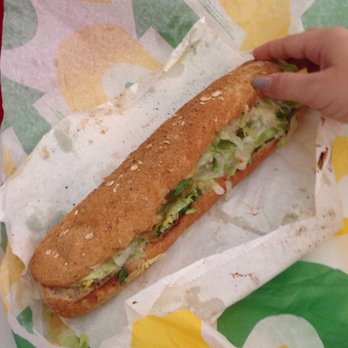Subway - a person holding a sandwich in a wrapper - Sandwiches Near Me - Marietta, Georgia Subway - a person holding a sandwich in a wrapper - Sandwiches Near Me - Marietta, Georgia