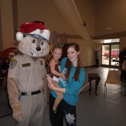Ignite Your Flare - Instructor, Katie Lindsey and student, Anistin Milton pose with Chipper the CHP mascot at the Children's Christmas Festival 2014