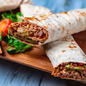 Mediterranean Soul - a burrito cut in half on a cutting board - Soul Food Near Me - Billings, Montana Mediterranean Soul - a burrito cut in half on a cutting board - Soul Food Near Me - Billings, Montana