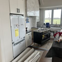 Appliance Shark - Appliance Shark's master installers doing great work to set up this new build with a built in Fisher & Paykel refrigerator and gas stove!