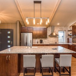 CSC Designs - Grand kitchen with island replaces a tired 1970s closed layout.