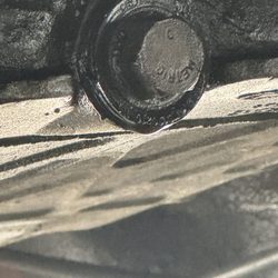 Victory Lane Quick Oil Change - Gasket maker and the old bolt they reused
