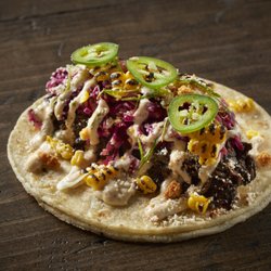 Taco Bamba Shirlington - taco with black chili bbq barbacoa, corn coleslaw, esquites crema, cheese, green onion, jalapeño, crispy onion