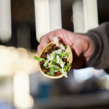 Señor Grubby's - a hand holding a taco - Mexican Near Me - Oceanside, California Señor Grubby's - a hand holding a taco - Mexican Near Me - Oceanside, California