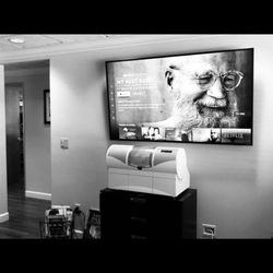 White Oaks Dental - Waiting area with mounted T.V and milling unit that makes their same day crowns