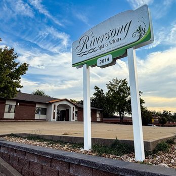 Riversong Spa & Salon - Exterior view of Riversong Spa & Salon in Jefferson City, Missouri, with the front sign and entrance shown under a partly cloudy sky. - Massage Near Me - Jefferson City, Missouri Riversong Spa & Salon - Exterior view of Riversong Spa & Salon in Jefferson City, Missouri, with the front sign and entrance shown under a partly cloudy sky. - Massage Near Me - Jefferson City, Missouri