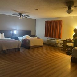 Motel 6 - The room was massive with three beds and a wide open space. Very dimly lit.