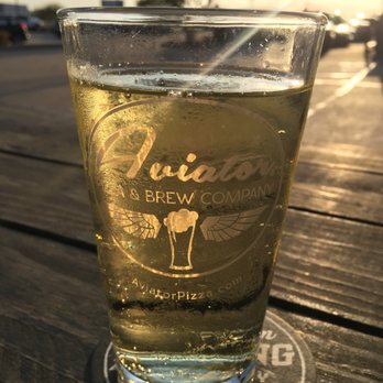 Aviator Pizza & Drafthouse - Outside on the patio, drinking a pear cider on draft. - Pizza Near Me - Elgin, Texas