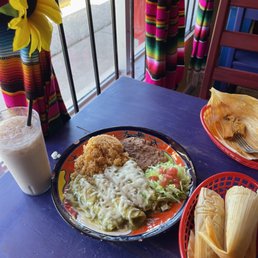 a plate of mexican food and a glass of milk a plate of mexican food and a glass of milk