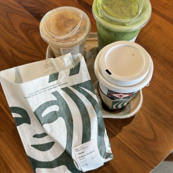 Starbucks - two cups of coffee and a paper bag on a table - Coffee & Tea Near Me - Stevenson Ranch, California