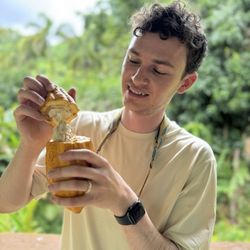 Lydgate Farms - Hubs opening up a cocoa pod our guide grabbed right off a tree. They're harvested year-round so you don't have to worry about missing out.